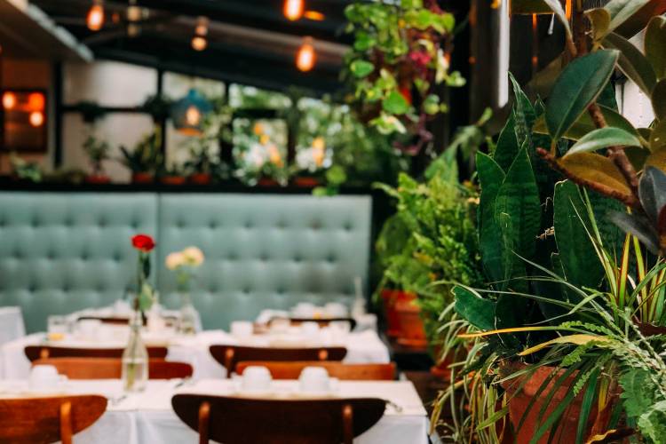 restaurant with white table cloths and green booth